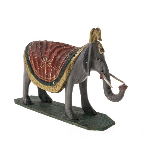 19. Jh. Krippenfigur, Elefant. Holz, farbig bemalt. Assistenzfigur der Drei Heiligen aus dem Morgenland. Part. best., Gebrauchsspuren. 12,5 x 18 cm.